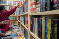 Kolkata, West Bengal, India - 2nd February 2020 : Beautiful young woman with spectacles reaching out to books inside a book stall Royalty Free Stock Photo