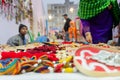 Indian man selling coloutful handmade jewelleries