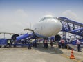 Passengers are boarding Indigo flight at Kolkata air port. Blue sky and white cloud