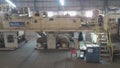 White Paper Reels are being cut into reams in a paper manufacturing plant. Indian