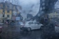 Kolkata, West Bengal, India - 25th September 2019 : Image shot through raindrops falling on wet glass, abstract blurs of traffic Royalty Free Stock Photo