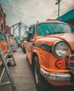 Kolkata, West Bengal: Outside Howrah Railway Station. Taxi line up for picking passengers. Howrah Bridge in background