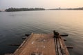 A wooden pier on the edge of the waters of the Ashtamudi lake in the town of Quilon Royalty Free Stock Photo