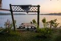 A wooden pier by the green banks of the Ashtamudi lake in the town of Quilon Royalty Free Stock Photo