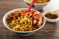 Kolo Mee is a Sarawak Malaysian dish of dry noodles tossed in a savoury pork and shallot mixture, topped off with fragrant fried