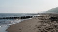 Kolobrzeg, Poland 28 Juli 2018. Misty morning on the Polish beach visible people, sea, screens and wooden breakwaters.