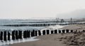 Kolobrzeg, Poland 28 Juli 2018. Misty morning on the Polish beach visible people, sea, screens and wooden breakwaters.