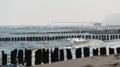 Kolobrzeg, Poland 28 Juli 2018. Misty morning on the Polish beach visible people, sea, screens and wooden breakwaters.