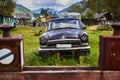 KOLOCHAVA, UKRAINE - 26 AUGUST 2020. Old car black color, stands in the grass. Rusty old vintage soviet car on narrow-gauge