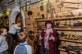 Kolomna, Russia - January 03, 2017: Female-guide Blacksmith Settlement museum visitors among
