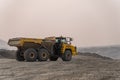 The Komatsu HM400 articulated dump truck operates in an open pit.