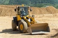 The Komatsu loader is working in an open pit.