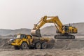 A Komatsu PC1250 excavator loads ore into a Komatsu HM400 dump truck