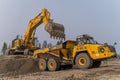 A Komatsu PC1250 excavator loads ore into a Komatsu HM400 dump truck