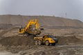 A Komatsu PC1250 excavator loads ore into a Komatsu HM400 dump truck.