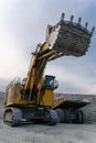 A Komatsu PC4000 excavator moves with a raised bucket in an open pit.