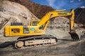 Komatsu PC300 yellow excavator in Almaty mountains involved in the construction of the dam