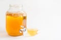 Kombucha-a drink made from tea mushroom in a glass jar with a tap. Transparent mug with a yeast drink made from a Japanese