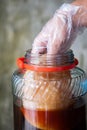 Kombucha SCOBY,Hand holding tea mushroom with kombucha tea