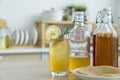 Kombucha tea with lemon and sweetened root filling in glass jug on kitchen background. Natural kombucha fermented tea beverage Royalty Free Stock Photo