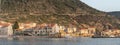 Komiza, Croatia - Aug 17, 2020: Panoramic view of old town beach on Vis Island during summer sunset Royalty Free Stock Photo