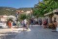 Komiza, Croatia - Aug 16, 2020: Tourists walk on old town port in sunny afternoon Royalty Free Stock Photo