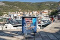 Komiza, Croatia - Aug 16, 2020: Travel agency information stand by old town port in summer Royalty Free Stock Photo