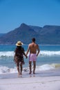 Kommetjie Public Beach Cape Town South Africa, white beach and blue ocean at Kommetjie couple man and woman walking at Royalty Free Stock Photo