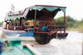 KOMPONG PHLUK, CAMBODIA - OCTOBER 24: Cambodian child rides in the back of a tourist boat to the village of Kompong Phluk on