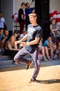 Komsomolsk-on-Amur, Russia, August 1, 2015. a boy dancing a break dance in the square with spectators