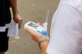 Male volunteer explains to people values of peak flow meter