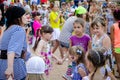 Girl dressed in a pirate costume leads roundelay with group of children