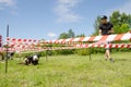 Man with a stopwatch watches as boy in the form of fireman crawl