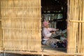 Kon Tum, Vietnam - Mar 28, 2016: Bahnar woman weaves clothing inside of her house in Kon Kotu village, 5km from Kon Tum city Royalty Free Stock Photo