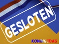 Dutch words gesloten Koningsdag closed King`s Day with an orange paper crown and a red white and blue ribbon Royalty Free Stock Photo