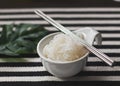 Konjac or Shirataki noodles in white bowl  with metal chopsticks, black and white stripe table cloth background Royalty Free Stock Photo