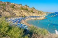 Konnos bay beach in Cyprus next to the Mediterranean Sea in the late afternoon with pleasure boats and concession area.
