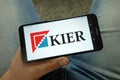 Man holding smartphone with Kier Group plc logo Royalty Free Stock Photo