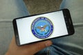 Man holding smartphone with United States Department of Defense logo