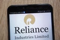 Reliance Industries logo displayed on a modern smartphone