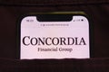 KONSKIE, POLAND - February 27, 2022: Concordia Financial Group logo on mobile phone hidden in jeans pocket