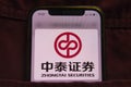 KONSKIE, POLAND - February 22, 2022: Zhongtai Securities company logo on mobile phone hidden in jeans pocket