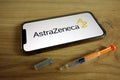 KONSKIE, POLAND - June 9, 2021: AstraZeneca plc logo on mobile phone with syringe. Covid-19 vaccine concept Royalty Free Stock Photo