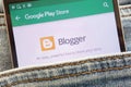 Blogger app on Google Play Store website displayed on smartphone hidden in jeans pocket