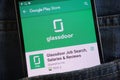 Glassdoor Job Search app on Google Play Store website displayed on smartphone hidden in jeans pocket