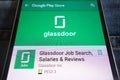 Glassdoor Job Search app on Google Play Store website displayed on smartphone hidden in jeans pocket