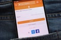 Odnoklassniki website displayed on smartphone hidden in jeans pocket