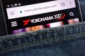 Yokohama Tire Corp website displayed on smartphone hidden in jeans pocket