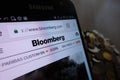 Bloomberg website displayed on Samsung smartphone and stack of coins Royalty Free Stock Photo