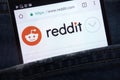 Reddit website displayed on smartphone hidden in jeans pocket